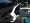 White powdercoated Strut Tower Brace next to stock engine stabilizer bar